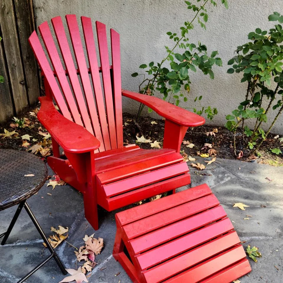 Red wooden Adirondack chair and matching footrest built by Stephen Calhoun