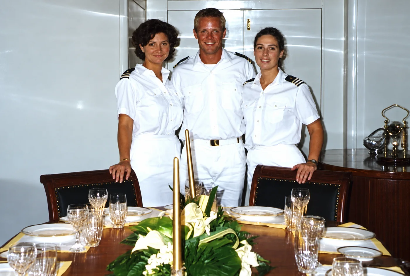 Stephen Calhoun standing with two fellow yacht crew members
